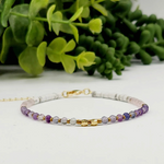 Calming stretch bracelet made with Fluorite, Amethyst, Rose Quartz, and Howlite beads for peace, clarity, and heart-centered energy
