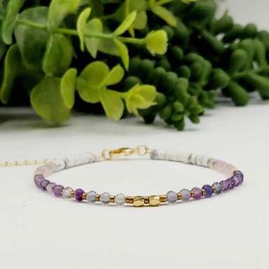 Calming stretch bracelet made with Fluorite, Amethyst, Rose Quartz, and Howlite beads for peace, clarity, and heart-centered energy