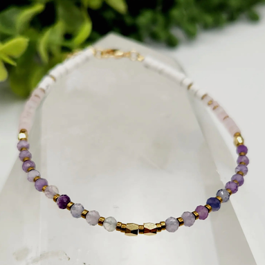 Calming stretch bracelet made with Fluorite, Amethyst, Rose Quartz, and Howlite beads for peace, clarity, and heart-centered energy