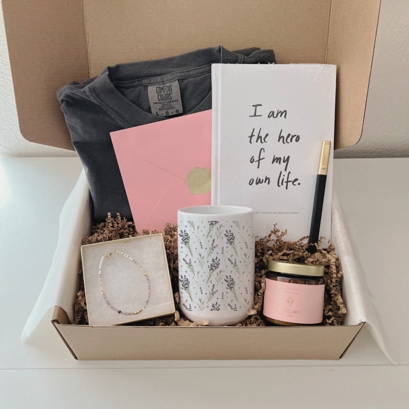 Support healing and self-love with this thoughtful gift set—includes journal, gemstone bracelet, lavender tee, rose quartz candle & mug.
