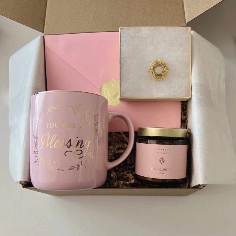 Encouragement mini gift box with gold-accented mug, gold acupressure ring, crystal candle, and affirmation card